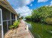 Peaceful Canal-Front Townhomes with Boat Parking & Pool in Maya Beach – Ideal for Living or Investment